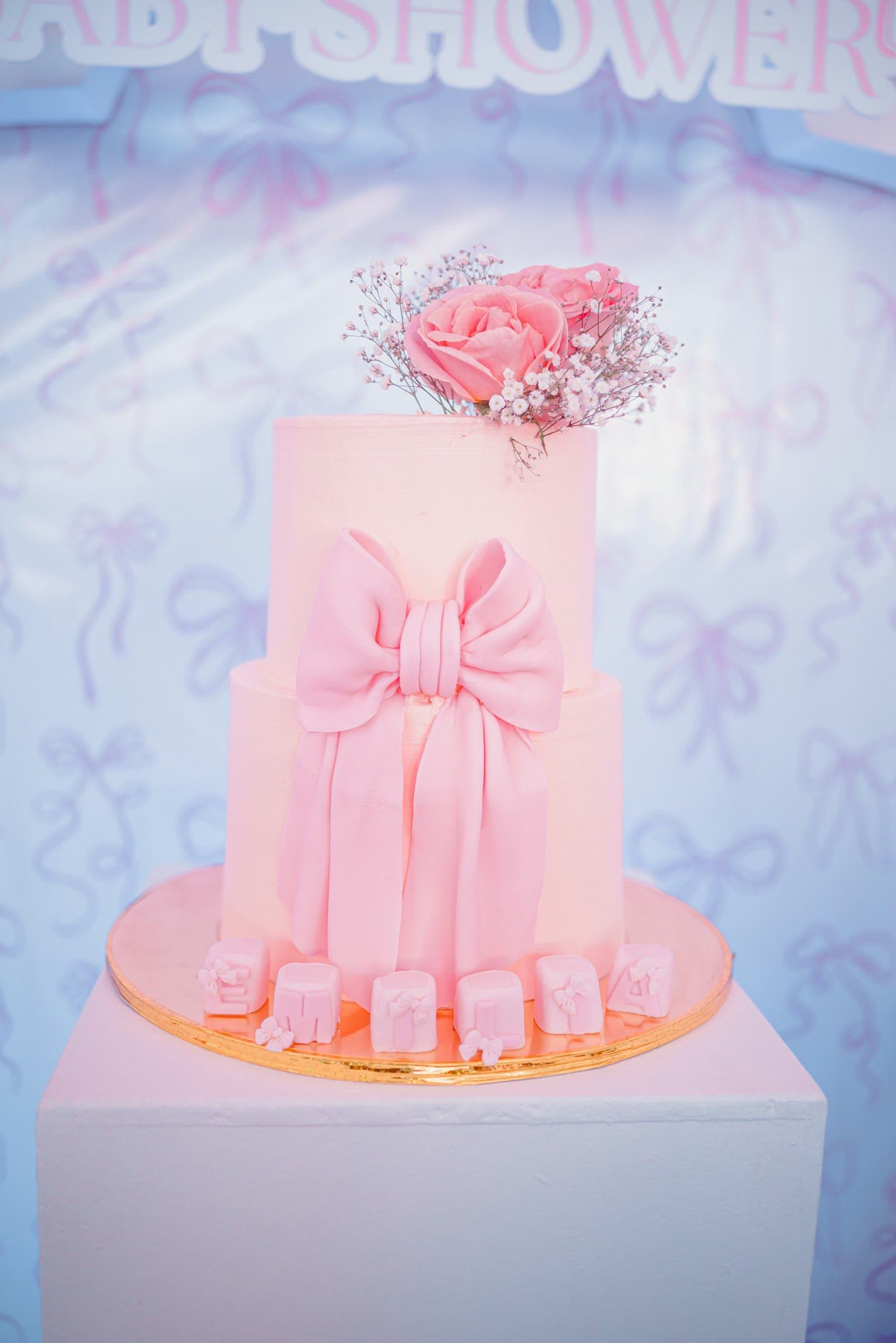 Two-tier pink cake with a bow