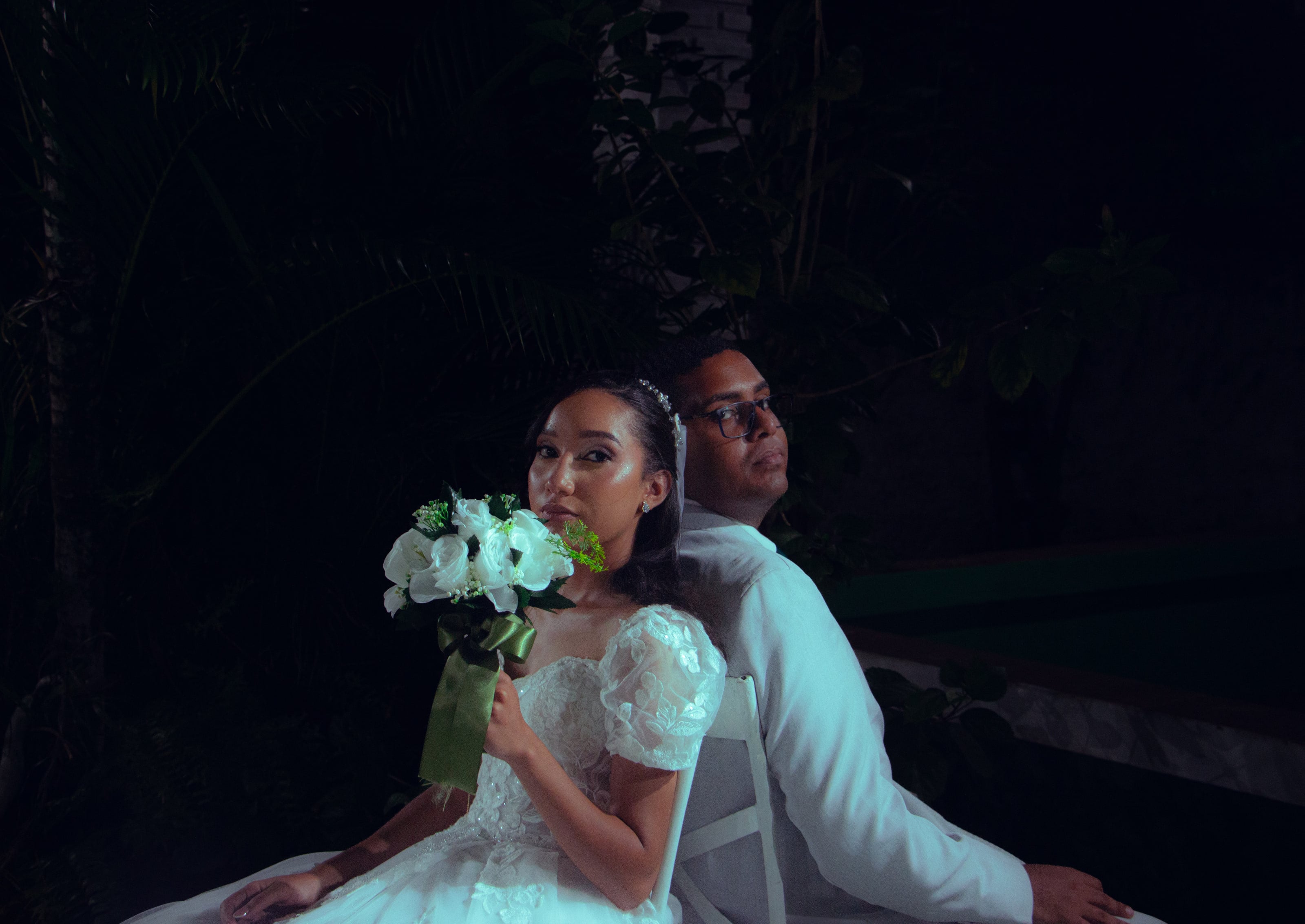 Retrato do casal sentado com o buquê de flores brancas, casamento de M & I